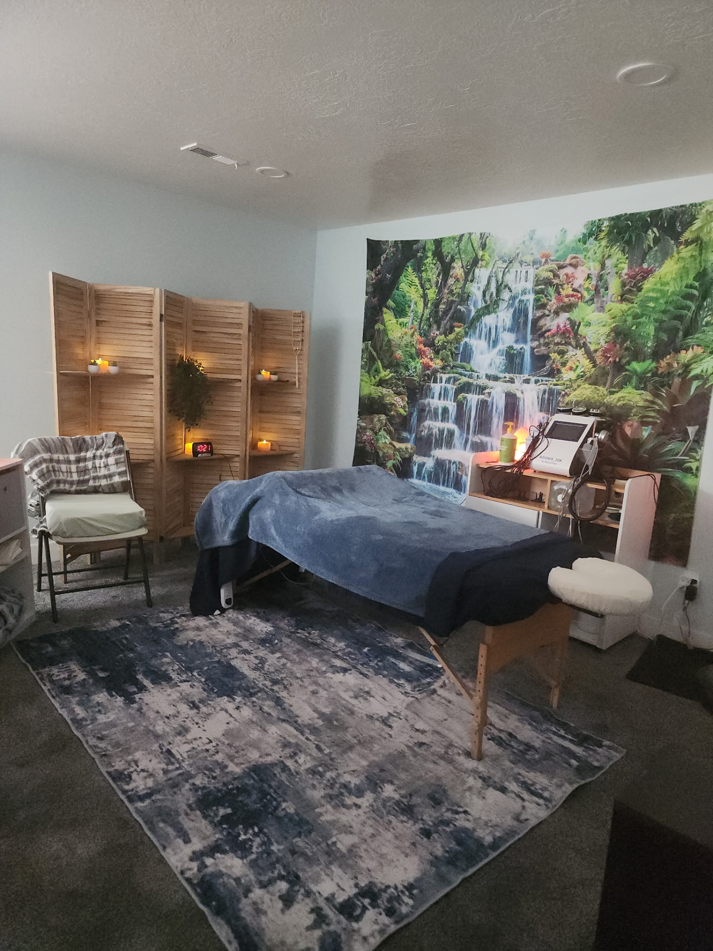 Treatment room with massage table, candles, and the RF cavitation machine